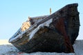 Old abandoned wooden fishing boat with rusted nails by the sea