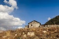 Old abandoned wooden house against the background of trees and a cloudy sky. Rural landscape. Gloomy house Royalty Free Stock Photo