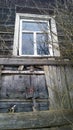 Old abandoned wooden house with broken window in disrepair from fairy tale. Dirty building exterior background. Wood material. Royalty Free Stock Photo