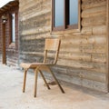 Old abandoned wooden house with chair outside Royalty Free Stock Photo