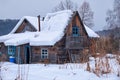 Old abandoned wooden house. The roof is covered with a thick layer of snow. Altai village Ust\'-Lebed\' in winter season Royalty Free Stock Photo