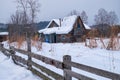 Old abandoned wooden house. The roof is covered with a thick layer of snow. Altai village Ust\'-Lebed\' in winter season Royalty Free Stock Photo