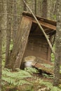 Old abandoned wooden outhouse in the woods Royalty Free Stock Photo
