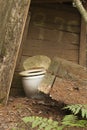 Old abandoned wooden outhouse in the woods