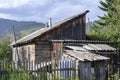 Old abandoned wooden village house on a hill in the mountains Royalty Free Stock Photo