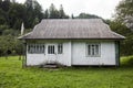 Old abandoned wooden village house surrounded by green forest in the Carpathian mountains, Burkut Royalty Free Stock Photo