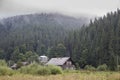 Old abandoned wooden village house surrounded by green forest in the Carpathian mountains, Burkut Royalty Free Stock Photo