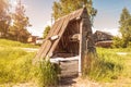 Old abandoned wooden well with beautiful structure in the Siberian village. Sunset Royalty Free Stock Photo