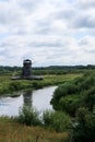 Old abandoned wooden windmill in the field by the river Royalty Free Stock Photo