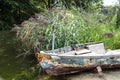 Old abandoned wrecked fishing boat at a lake