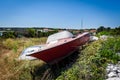 Old abandoned wrecked speed boat at ship or boat graveyard.