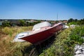 Old abandoned wrecked speed boat at ship or boat graveyard. Royalty Free Stock Photo