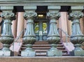 Old academic building detail - Silver painted balustrade with pink marble steps and entrance door visible showing through Royalty Free Stock Photo