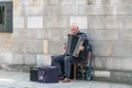 Old accordionist plays music in Krak=au