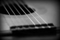 Old acoustic guitar with cracks on the soundboard. Black and white