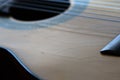 Old acoustic guitar with cracks on the soundboard