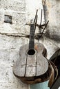 Old acoustic guitar hanging on the concrete wall Royalty Free Stock Photo