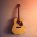 old acoustic guitar on a sandy texture. sunlight.