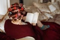 Old active senior woman with rollers in hair take care of herself on her day off. Relaxing and resting on coach at home Royalty Free Stock Photo