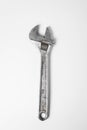 An old adjustable spanner lies on a white background. Royalty Free Stock Photo