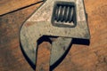 Old adjustable wrench on a wooden background. working tool. plumbing repairing instrument Royalty Free Stock Photo