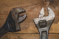 Old adjustable wrench on a wooden background. working tool. plumbing repairing instrument Royalty Free Stock Photo