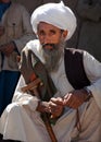 An old Afghan man with a grey beard in a remote village in Afghanistan near Chaghcharan. Royalty Free Stock Photo