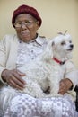 old african lady with her maltese dog Royalty Free Stock Photo