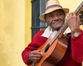 Old afrocuban street musician playing the guitar in Havana