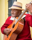 Old afrocuban street musician playing the guitar in Havana