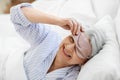 senior woman with eye sleeping mask in bed at home Royalty Free Stock Photo