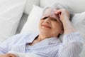 senior woman with eye sleeping mask in bed at home Royalty Free Stock Photo