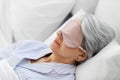 senior woman with eye mask sleeping in bed at home Royalty Free Stock Photo