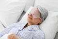 senior woman with eye mask sleeping in bed at home Royalty Free Stock Photo