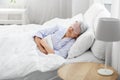 senior woman with eye mask sleeping in bed at home Royalty Free Stock Photo