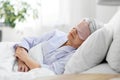 senior woman with eye mask sleeping in bed at home Royalty Free Stock Photo