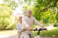 Happy senior couple riding on bicycle at park Royalty Free Stock Photo