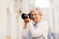 Senior woman photographing by digital camera Royalty Free Stock Photo