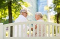 Happy senior couple sitting on bench at park Royalty Free Stock Photo