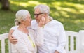 Happy senior couple sitting on bench at park Royalty Free Stock Photo