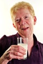 old age woman is holding a glass of milk Royalty Free Stock Photo