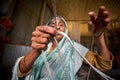 An old age woman is making fiber rope at Madhupur, Tangail, Bangladesh