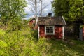 Old aged abandoned cabin house in the woods. Dacha or guest house. Nobody lives there. The old wooden building fell into disrepair Royalty Free Stock Photo