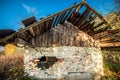 Old aged and damaged wooden house in fall