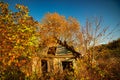 Old aged and damaged wooden house in fall