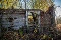 Old aged and damaged wooden house in fall