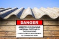 Old aged dangerous asbestos roof - concept with placard indicating danger Royalty Free Stock Photo