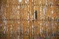 Old aged door with metal ornaments on orange painted natural wood Royalty Free Stock Photo