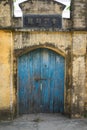 Old aged house gate and wall made of laterite in Duong Lam ancient village, Son Tay district, Hanoi, Vietnam Royalty Free Stock Photo