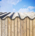 Old aged roof made of corrugated asbestos panels - dangerous materials in buildings and construction industry